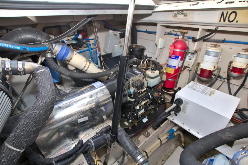 Slide: The Image of Engine room of 2013 Sea Ray 450 Sundancer with visible machinery and fire extinguisher. - 48