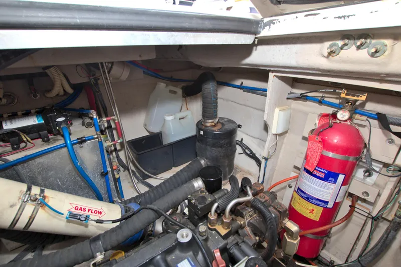 Slide: The Image of Engine compartment of 2013 Sea Ray 450 Sundancer with fire extinguisher and gas flow system. - 49