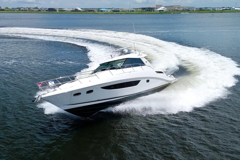 Slide: The Image of 2013 Sea Ray 450 Sundancer yacht making a sharp turn on open water. - 8