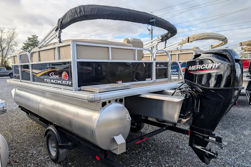 Slide: The Image of 2025 Sun Tracker Party Barge 16 DLX pontoon boat with Mercury outboard motor. - 2