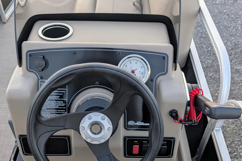 Slide: The Image of 2025 Sun Tracker Party Barge 16 DLX steering console with gauge and controls. - 6