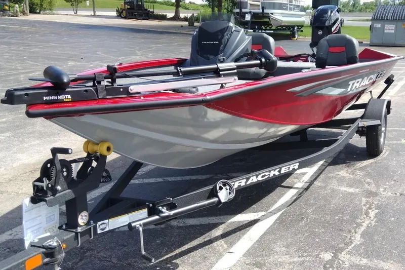 Slide: The Image of 2025 Tracker Pro Team 175 Crappie Edition boat on trailer, featuring Minn Kota motor. - 2