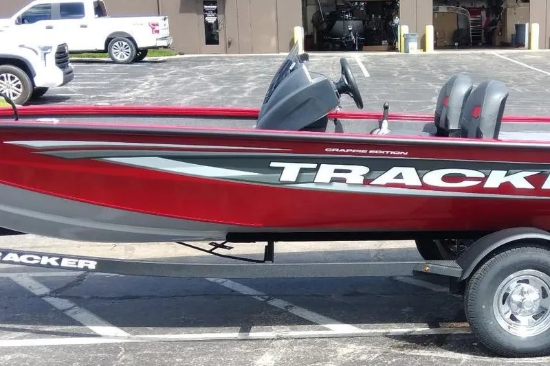 Slide: The Image of 2025 Tracker Pro Team 175 Crappie Edition boat, red and gray, parked on trailer. - 3