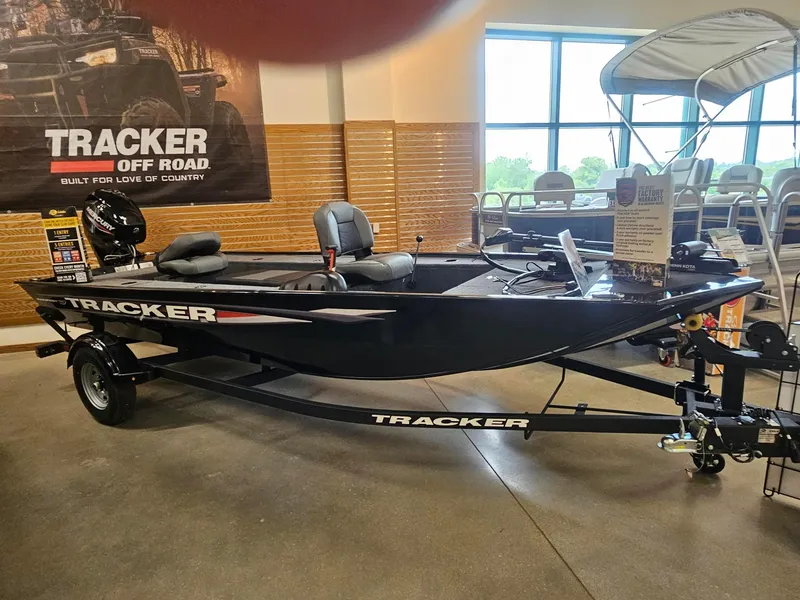 The Image of 2025 Tracker Panfish 17 boat displayed indoors with promotional materials. - 0