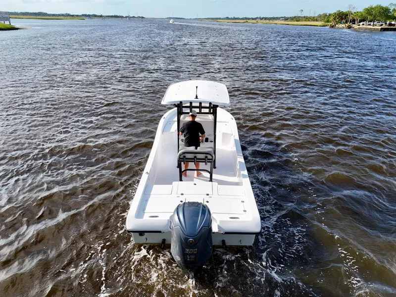 Slide: The Image of 2025 Action Craft 24 Coastal Bay boat cruising on open water. - 10