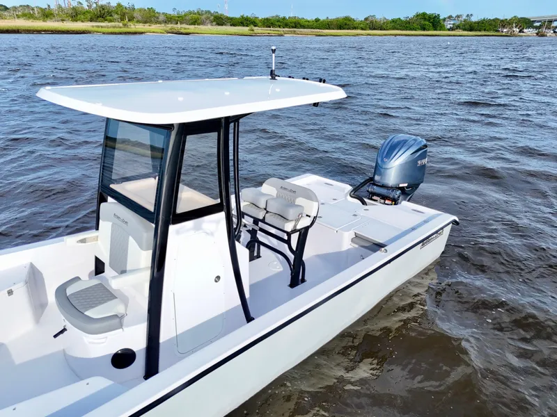 Slide: The Image of 2025 Action Craft 24 Coastal Bay boat on water, featuring sleek design and modern outboard motor. - 15