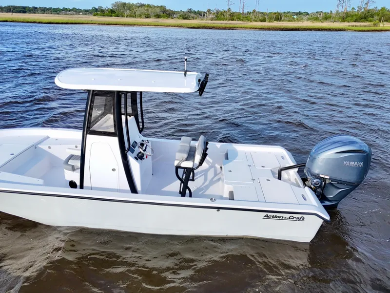 Slide: The Image of 2025 Action Craft 24 Coastal Bay boat on water, featuring sleek design and Yamaha engine. - 16