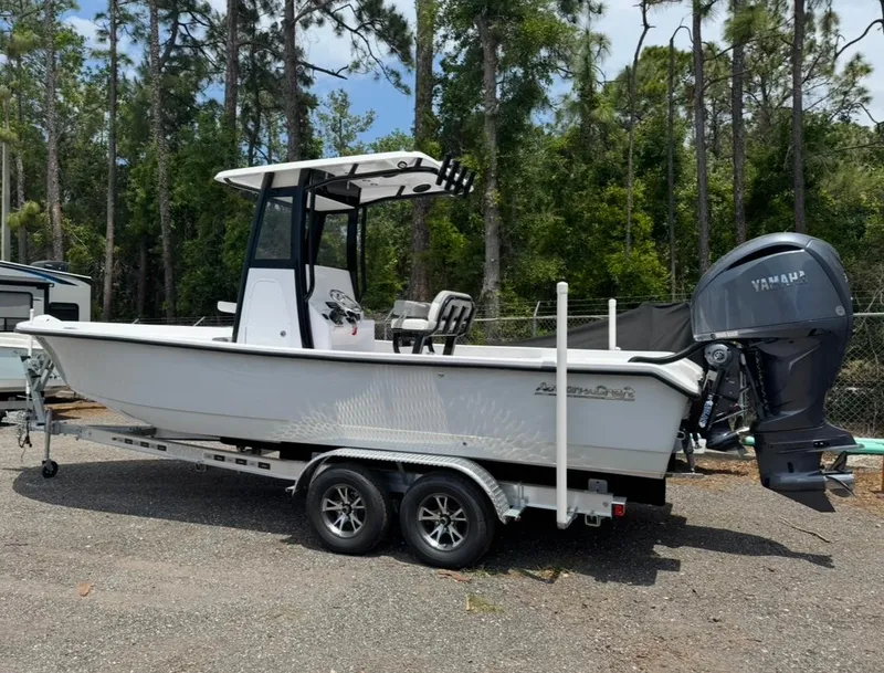 Slide: The Image of 2025 Action Craft 24 Coastal Bay boat on trailer, parked outdoors. - 27