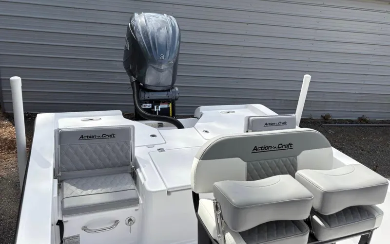 Slide: The Image of 2025 Action Craft 24 Coastal Bay boat interior with seating and motor. - 31