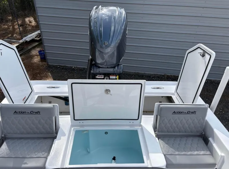 Slide: The Image of 2025 Action Craft 24 Coastal Bay boat with open storage compartments and seating. - 33