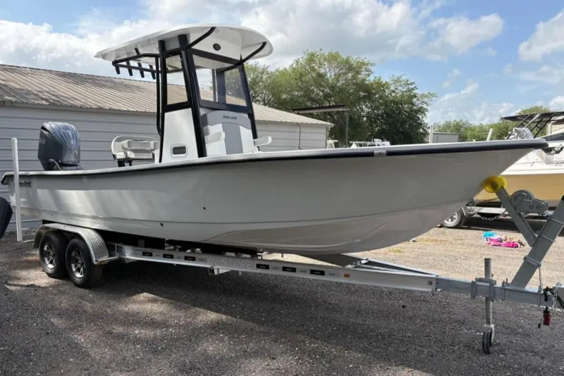 Slide: The Image of 2025 Action Craft 24 Coastal Bay boat on trailer, parked outdoors. - 35