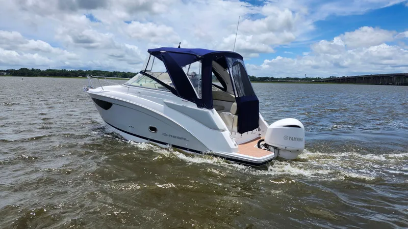 Slide: The Image of 2020 Regal 26 XO boat cruising on a sunny day with Yamaha outboard motor. - 1