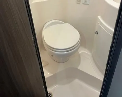 Slide: The Image of 2020 Regal 26 XO boat bathroom interior with compact toilet design. - 11