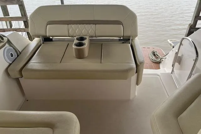 Slide: The Image of 2020 Regal 26 XO boat interior with beige seating and cup holders. - 12