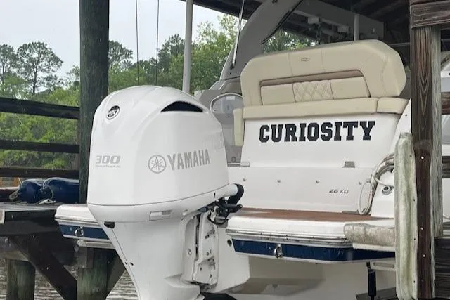 Slide: The Image of 2020 Regal 26 XO boat with Yamaha 300 engine, docked, featuring "Curiosity" name. - 14