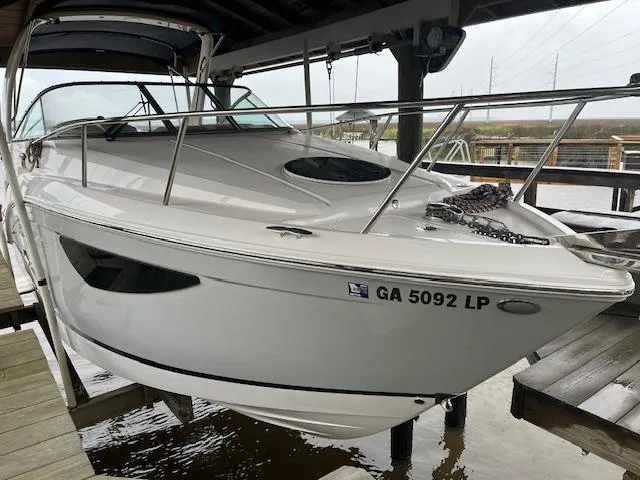 Slide: The Image of 2020 Regal 26 XO boat docked, white exterior, registration GA 5092 LP, under covered marina. - 2