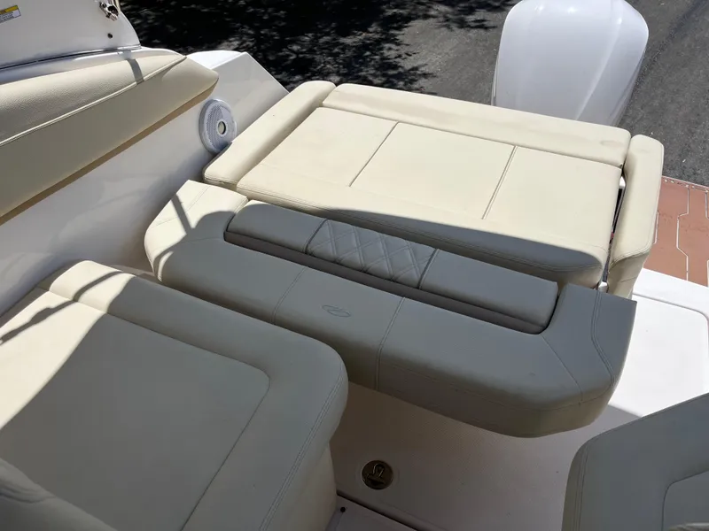 Slide: The Image of 2020 Regal 26 XO boat interior with beige cushioned seating and speaker. - 21