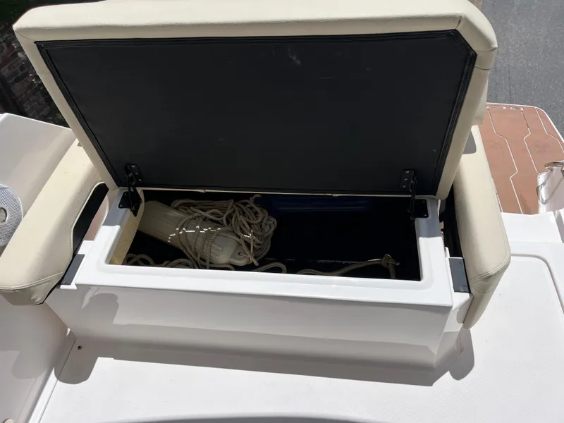 Slide: The Image of Open storage compartment on 2020 Regal 26 XO boat with ropes and fender inside. - 26