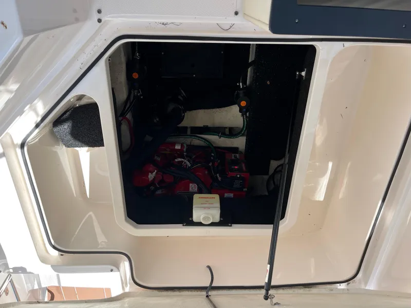 Slide: The Image of Engine compartment of a 2020 Regal 26 XO boat, showing batteries and wiring. - 27
