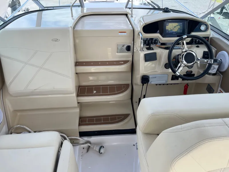 Slide: The Image of 2020 Regal 26 XO boat cockpit with steering wheel and navigation system. - 28