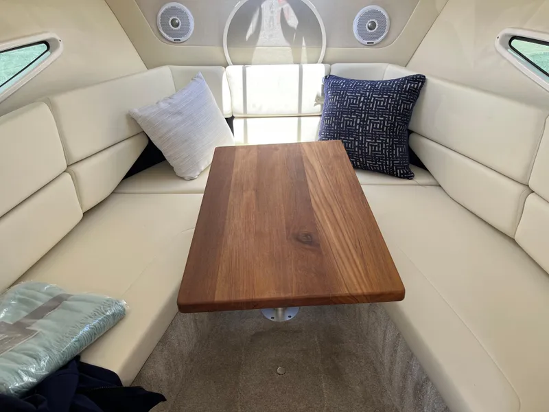 Slide: The Image of Interior of 2020 Regal 26 XO boat with cozy seating and wooden table. - 30