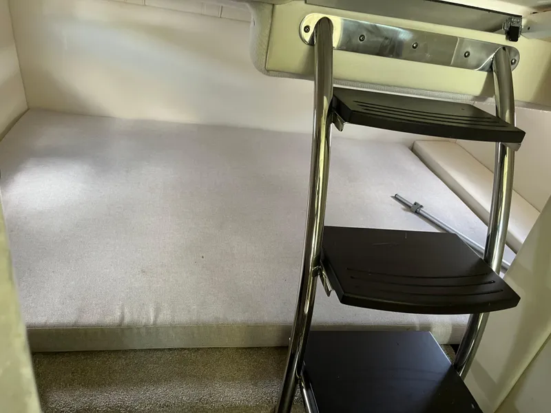 Slide: The Image of Interior cabin of 2020 Regal 26 XO boat with ladder and cushioned seating area. - 34