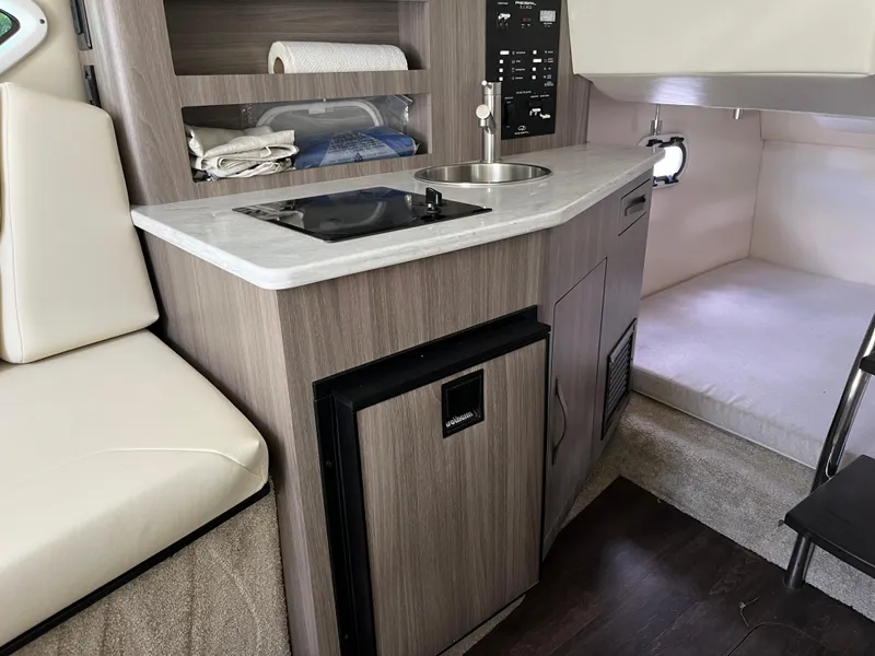 Slide: The Image of 2020 Regal 26 XO boat interior with kitchenette and sleeping area. - 36