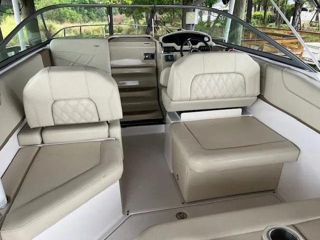 Slide: The Image of 2020 Regal 26 XO boat interior with beige seating and steering console. - 4