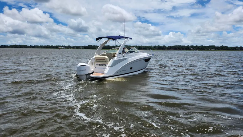 Slide: The Image of 2020 Regal 26 XO boat cruising on a lake under a partly cloudy sky. - 41