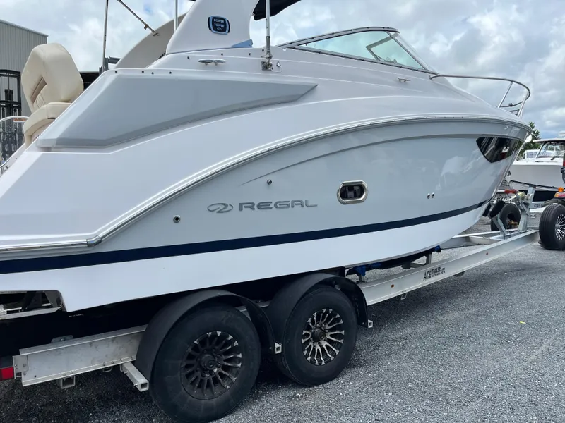 Slide: The Image of 2020 Regal 26 XO boat on trailer, side view, parked outdoors. - 45