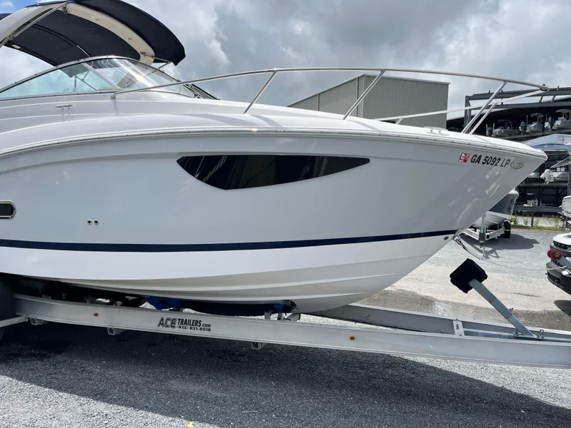 Slide: The Image of 2020 Regal 26 XO boat on trailer, parked outdoors under cloudy sky. - 46