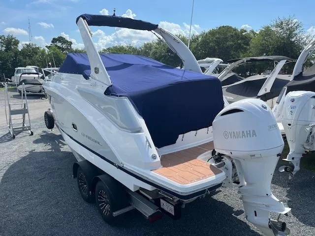 Slide: The Image of 2020 Regal 26 XO boat with Yamaha outboard motor, covered in blue tarp, on trailer. - 48