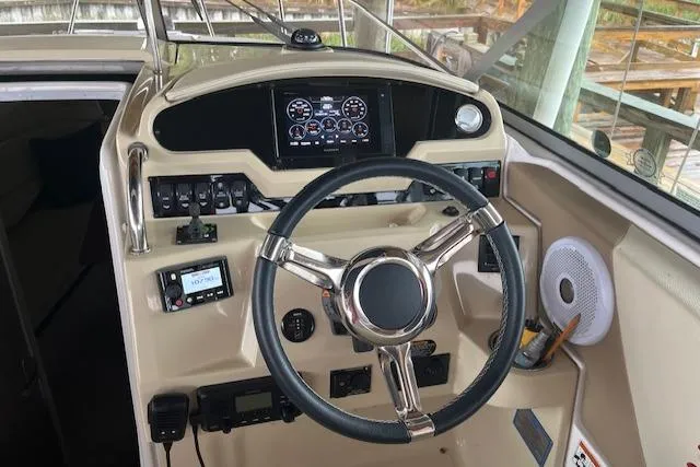 Slide: The Image of 2020 Regal 26 XO boat dashboard with steering wheel and control panel. - 5