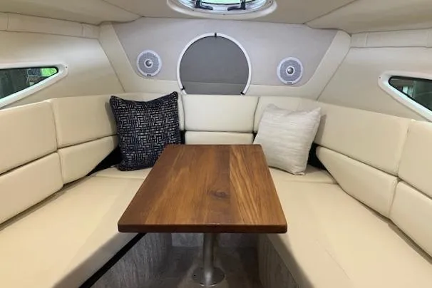 Slide: The Image of Luxurious interior of 2020 Regal 26 XO boat with cozy seating and wooden table. - 7