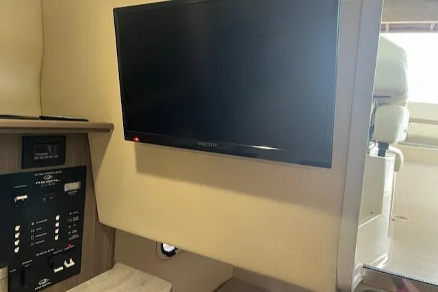 Slide: The Image of 2020 Regal 26 XO interior with mounted TV and control panel. - 8