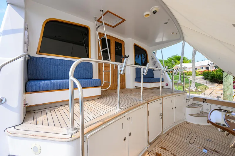 Slide: The Image of 2004 Sea Force IX 82 Enclosed Bridge yacht deck with seating and ladder. - 1