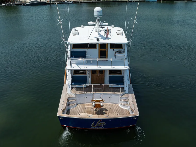 Slide: The Image of 2004 Sea Force IX 82 Enclosed Bridge yacht on calm water, rear view. - 12