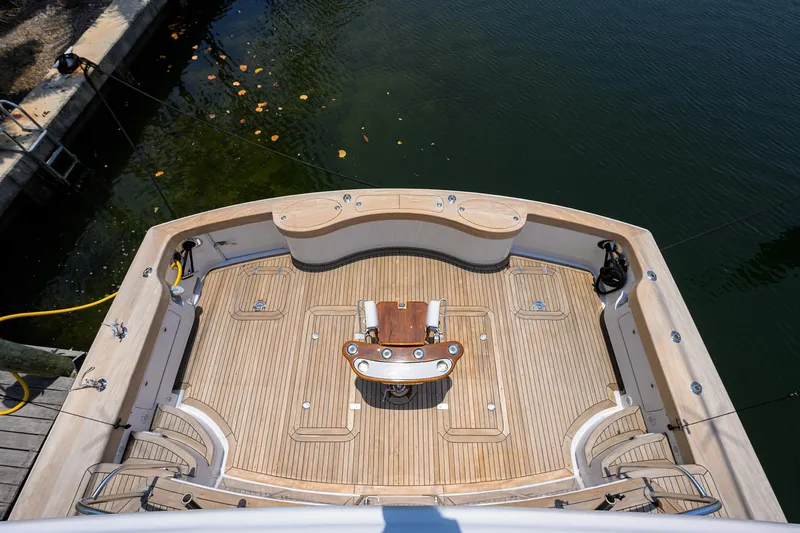 Slide: The Image of 2004 Sea Force IX 82 Enclosed Bridge yacht deck with wooden flooring and fishing chair. - 14