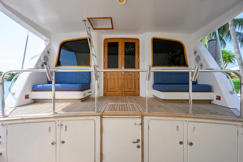 Slide: The Image of 2004 Sea Force IX 82 Enclosed Bridge yacht with wooden deck and blue seating. - 16