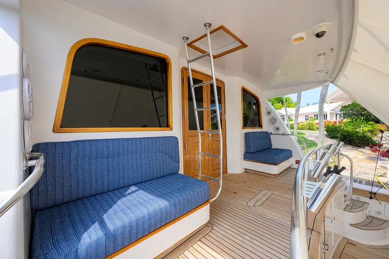 Slide: The Image of 2004 Sea Force IX 82 Enclosed Bridge yacht interior with blue seating and wooden accents. - 18