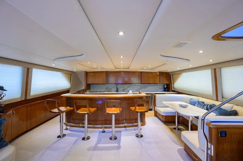 Slide: The Image of Luxurious interior of 2004 Sea Force IX 82 Enclosed Bridge yacht with modern seating and bar area. - 23