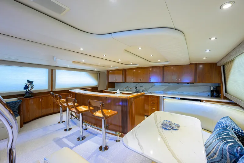Slide: The Image of Luxurious interior of 2004 Sea Force IX 82 Enclosed Bridge yacht with modern kitchen and seating. - 24