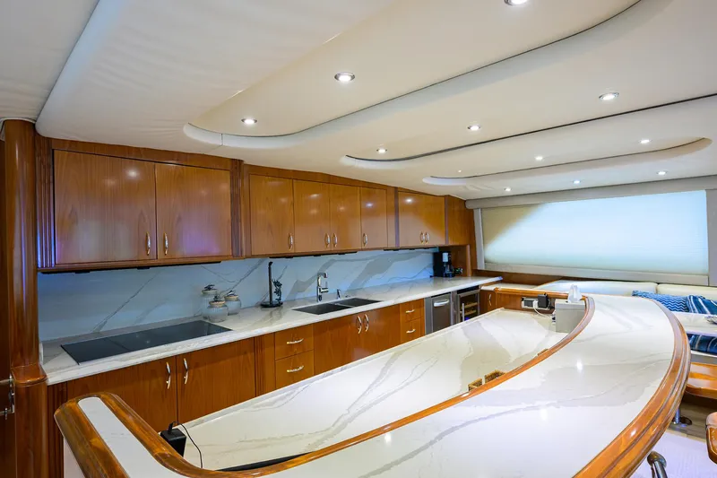 Slide: The Image of Luxurious kitchen interior of 2004 Sea Force IX 82 Enclosed Bridge yacht with wooden cabinetry. - 25