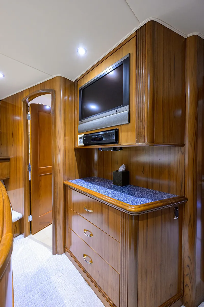 Slide: The Image of Luxurious wooden interior of 2004 Sea Force IX 82 Enclosed Bridge yacht with TV and storage. - 42