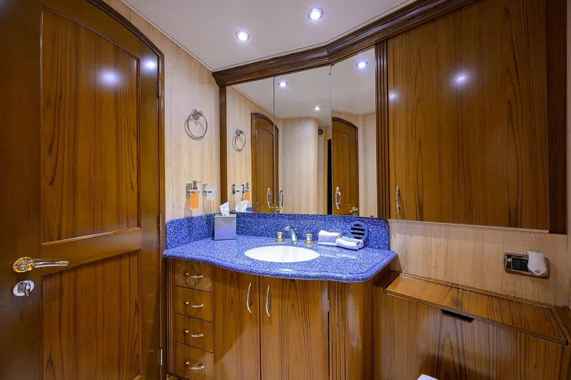Slide: The Image of Luxurious bathroom in 2004 Sea Force IX 82 Enclosed Bridge yacht with wood cabinetry and blue countertop. - 43