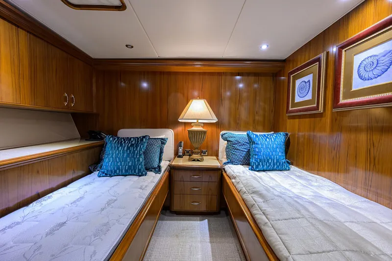 Slide: The Image of Luxurious twin cabin on 2004 Sea Force IX 82 Enclosed Bridge yacht with elegant wood paneling. - 46