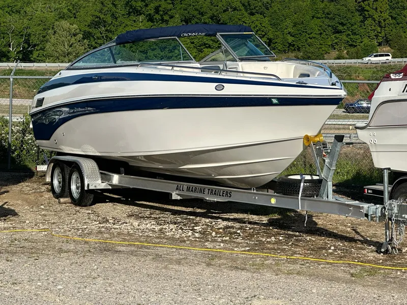 Slide: The Image of 2006 Crownline 270 BR boat on trailer, parked outdoors. - 0