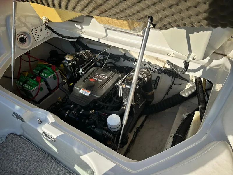 Slide: The Image of Engine compartment of a 2006 Crownline 270 BR boat, featuring dual batteries and a MerCruiser engine. - 10