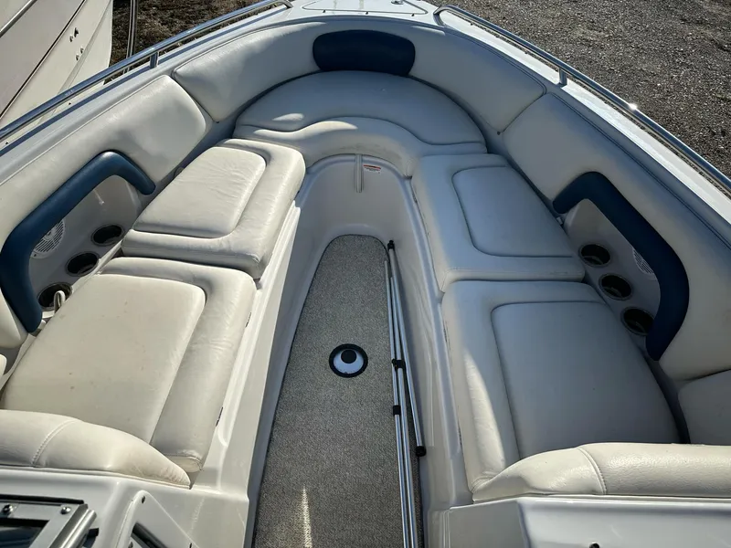 Slide: The Image of 2006 Crownline 270 BR boat interior with white cushioned seating and blue accents. - 12