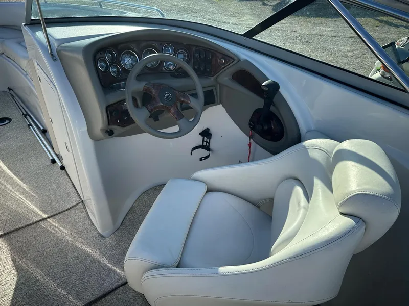 Slide: The Image of 2006 Crownline 270 BR boat cockpit with steering wheel and control panel. - 13